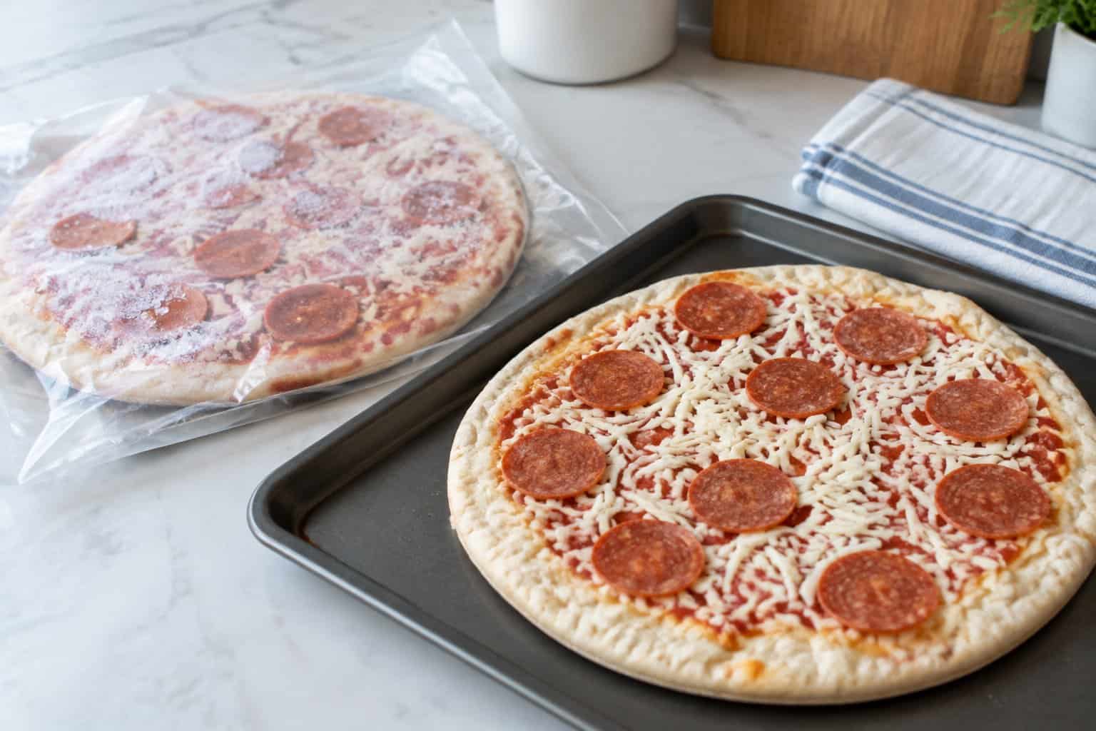 A frozen pepperoni pizza beside its opened package on a kitchen counter.